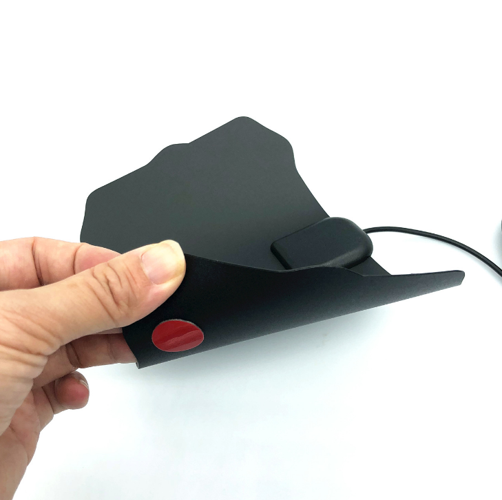 A hand holding the antenna, showing how thin and light the panel is
